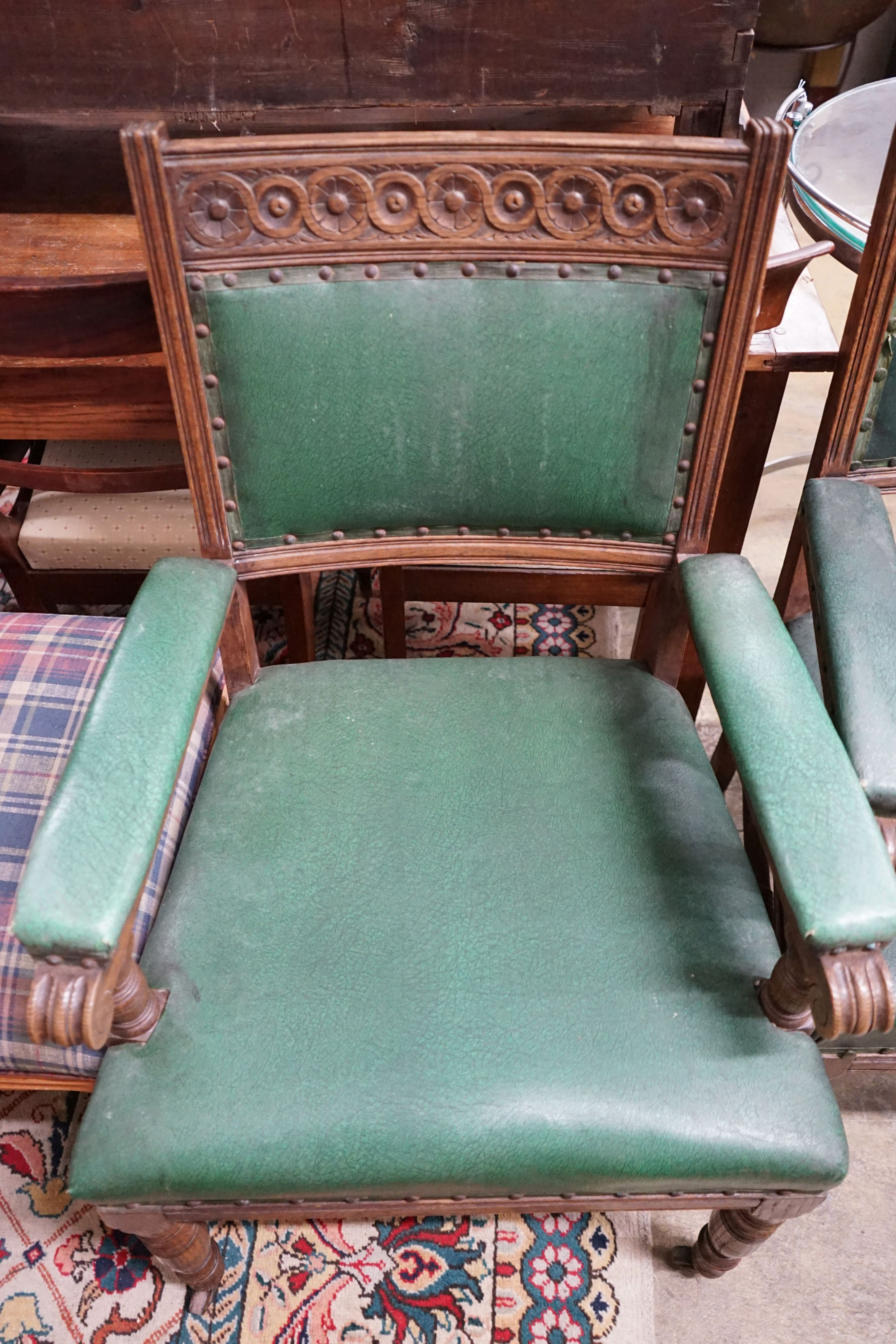 A pair of late Victorian carved oak elbow chairs, width 60cm, depth 53cm, height 100cm